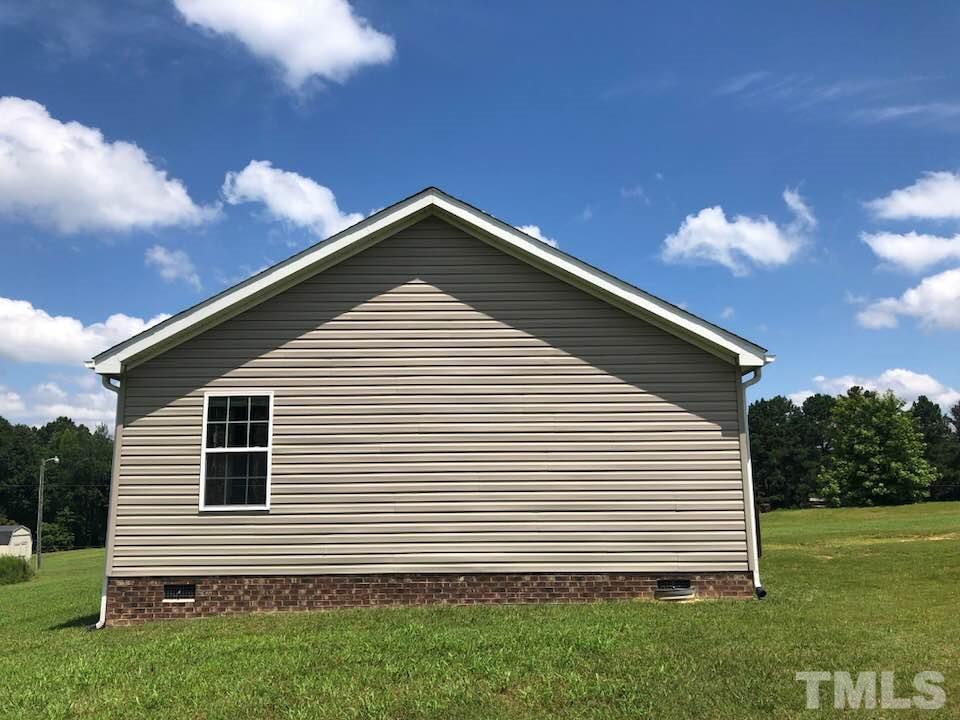 855 Chub Lake Loop Road Roxboro, NC 27574 - Photo 21 of 24 a front view of a house with a yard