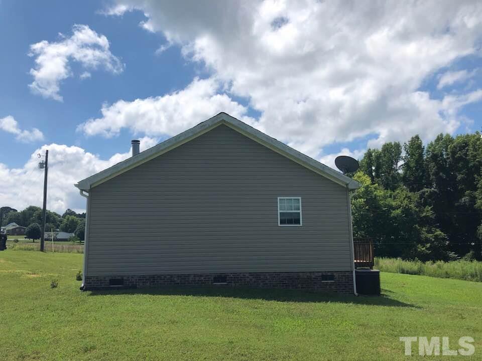 855 Chub Lake Loop Road Roxboro, NC 27574 - Photo 22 of 24 a backyard of a house with lots of green space