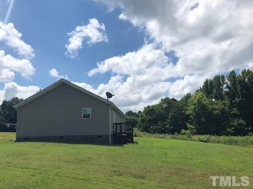 855 Chub Lake Loop Road Roxboro, NC 27574 - Photo 23 of 24 a house with trees in the background