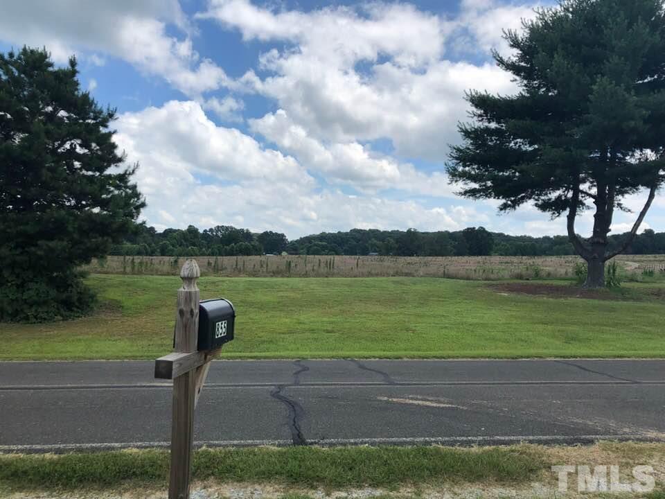 855 Chub Lake Loop Road Roxboro, NC 27574 - Photo 24 of 24 a lake view with a garden and trees