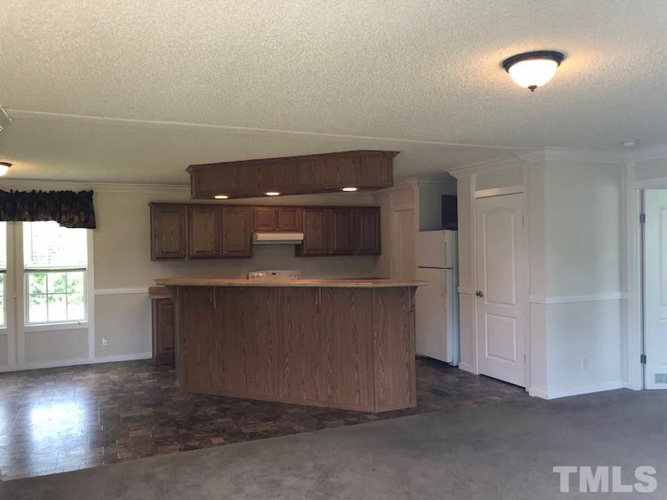 855 Chub Lake Loop Road Roxboro, NC 27574 - Photo 7 of 24 wooden floor in an empty room with a window