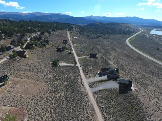 a view of a backyard with wooden fence