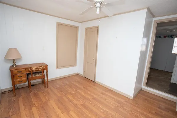 an empty room with wooden floor table and a chair