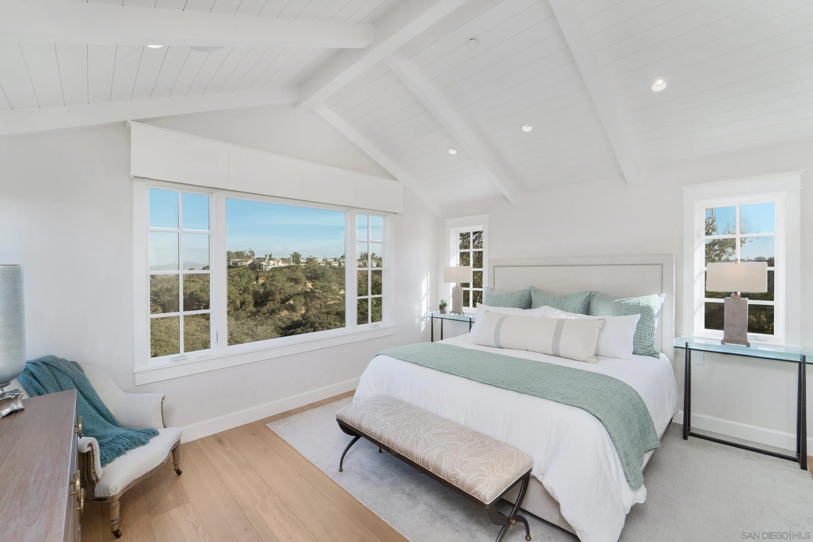 1145 Crest Road Del Mar, CA 92014 - Photo 28 of 57 a spacious bedroom with a large bed and a window