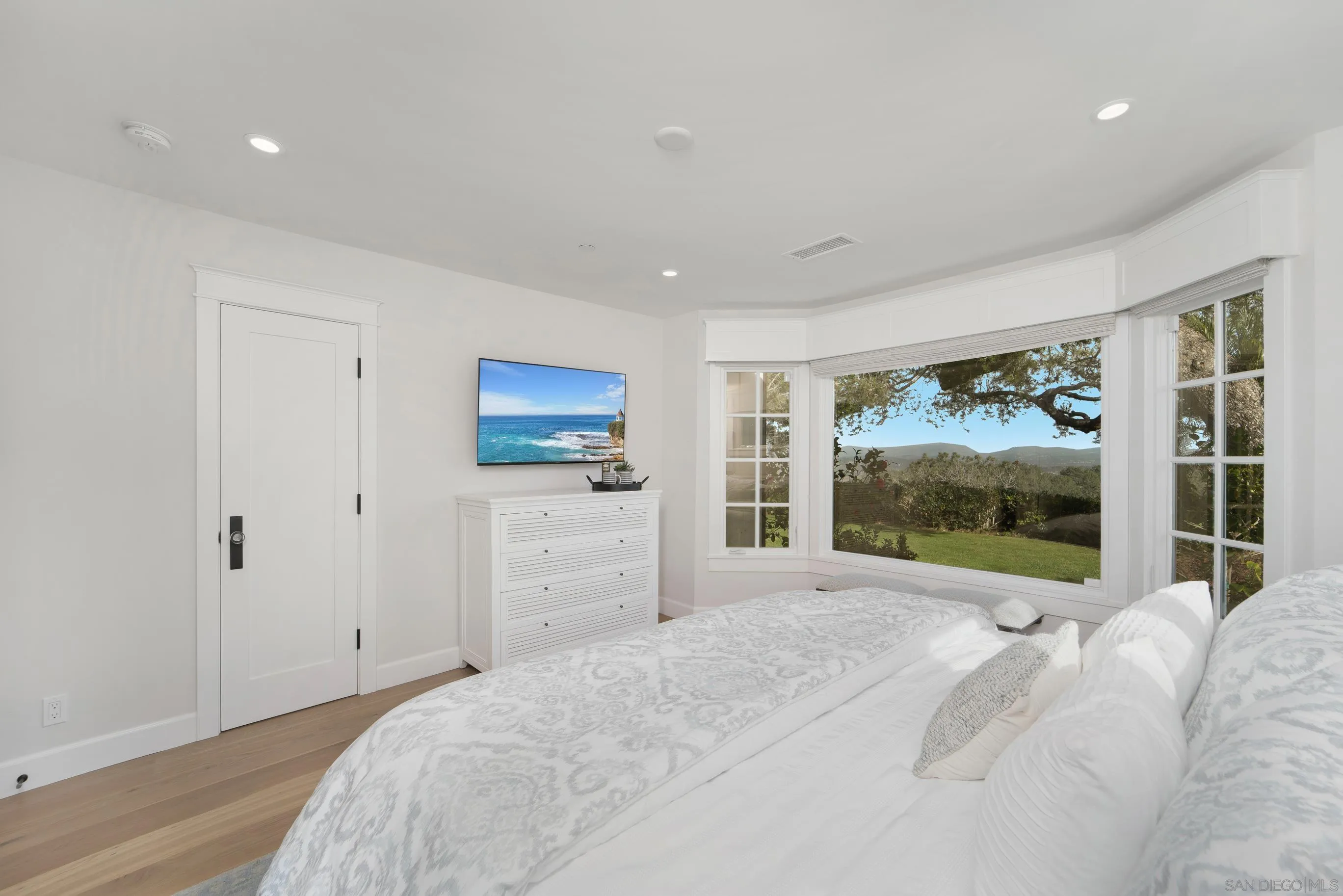1145 Crest Road Del Mar, CA 92014 - Photo 35 of 57 a bedroom with a bed and a large window