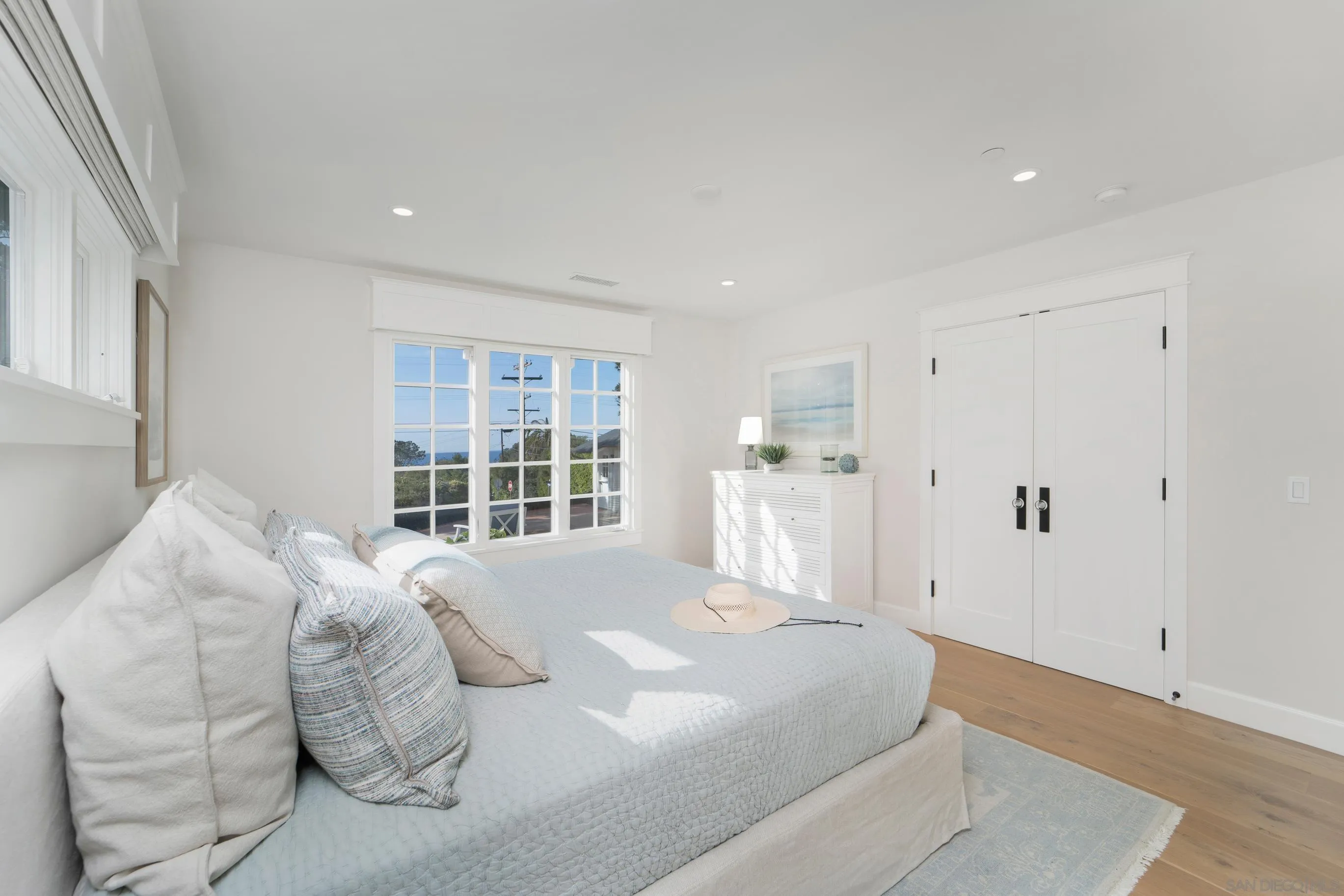 1145 Crest Road Del Mar, CA 92014 - Photo 37 of 57 a spacious bedroom with a large bed and a large window