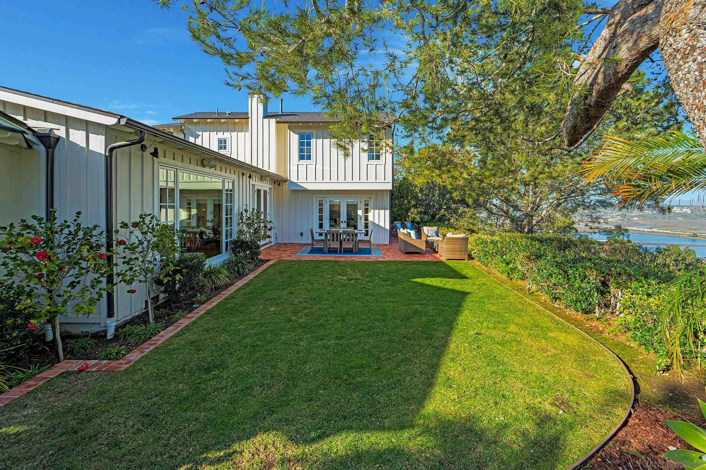 1145 Crest Road Del Mar, CA 92014 - Photo 49 of 57 a view of a house with a big yard potted plants and large tree
