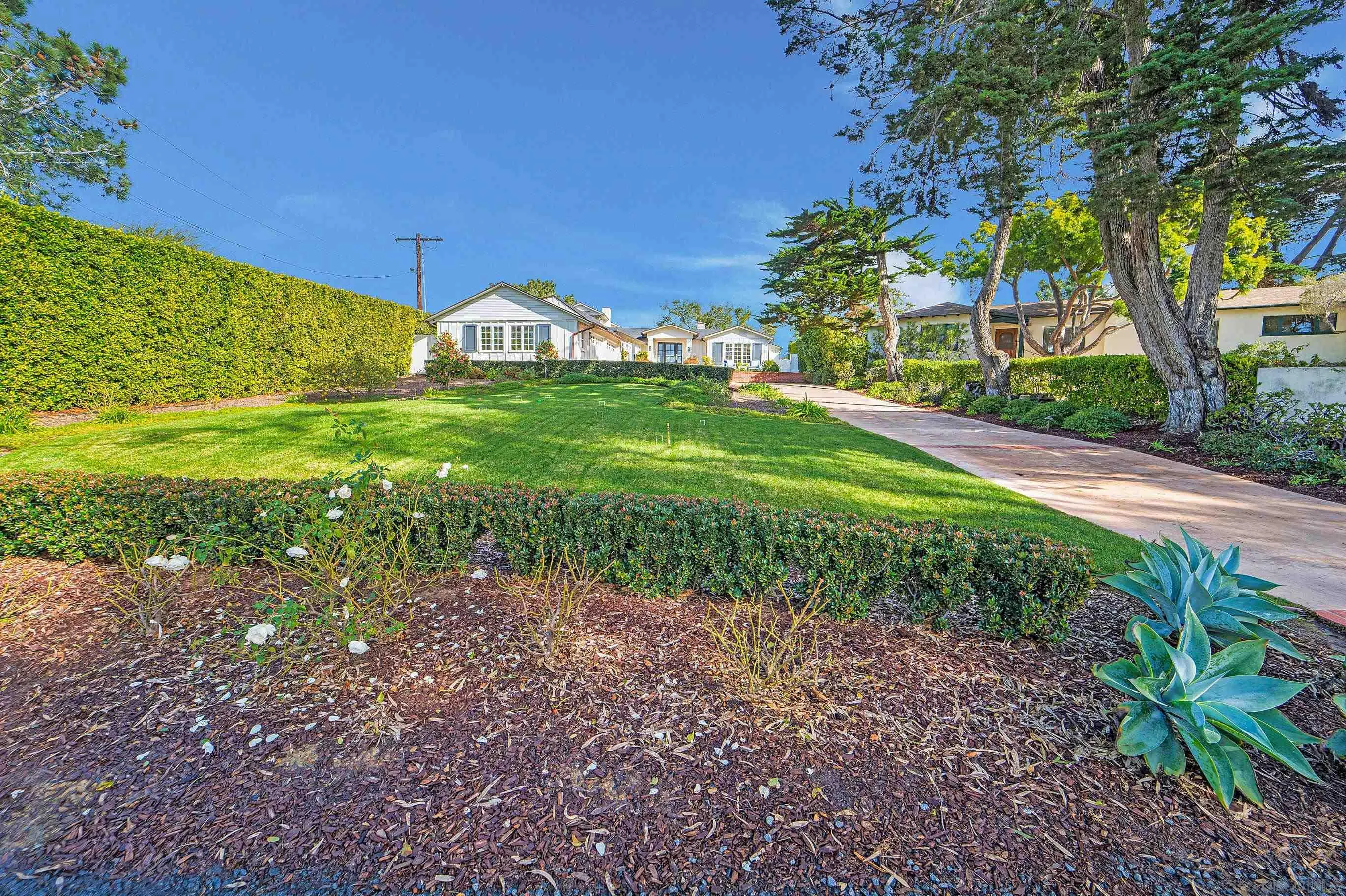 1145 Crest Road Del Mar, CA 92014 - Photo 50 of 57 a front view of a house with garden