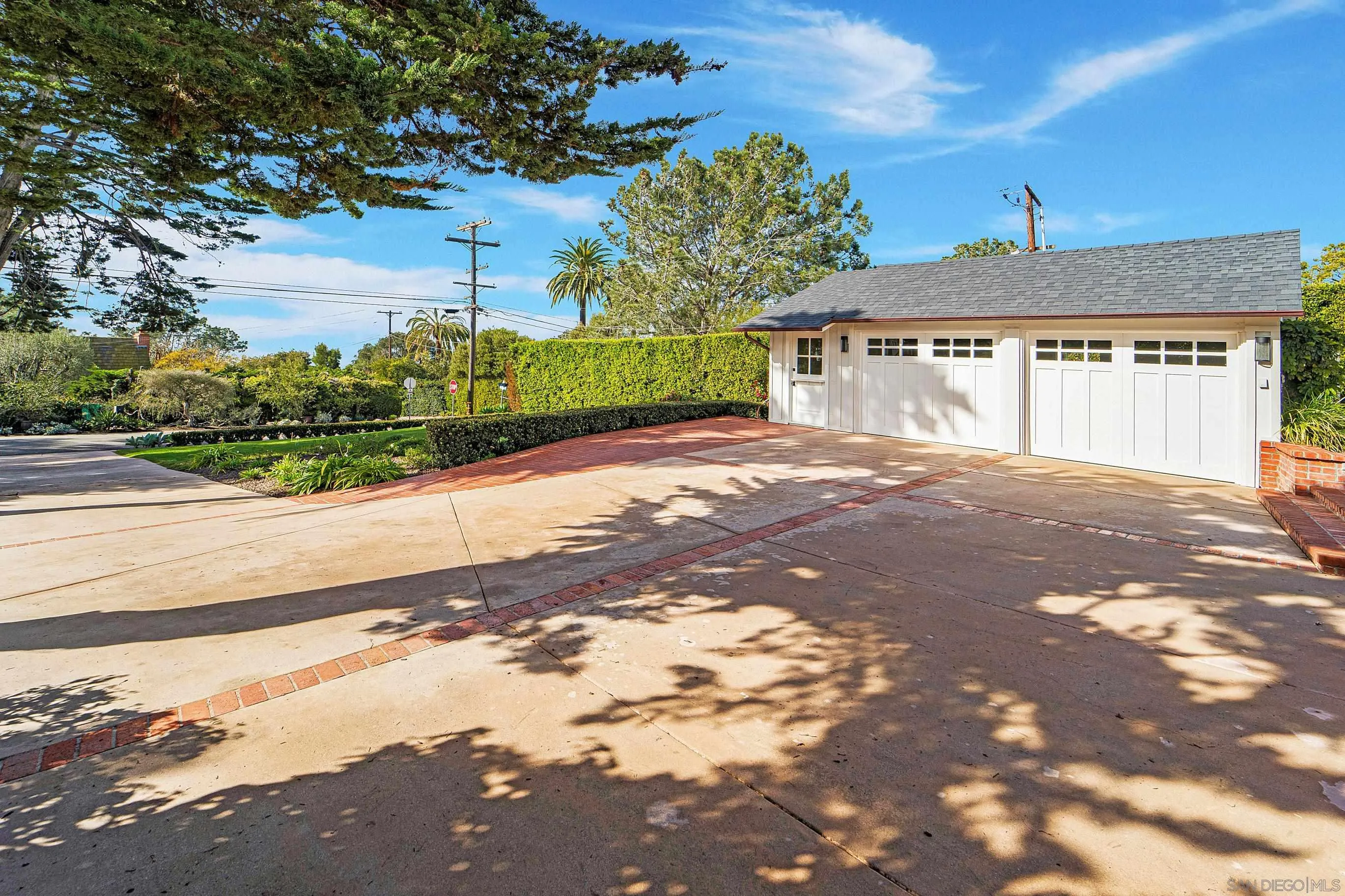 1145 Crest Road Del Mar, CA 92014 - Photo 51 of 57 a front view of a house with a yard and garage