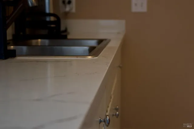 a kitchen with white cabinets and a sink