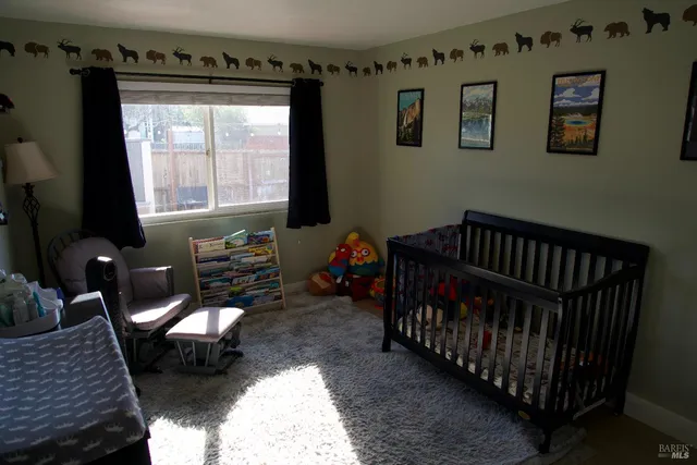 a bedroom with furniture and a window