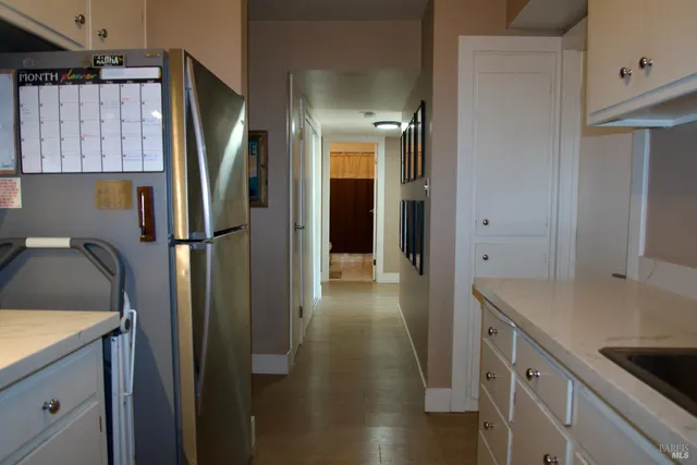 a kitchen with a refrigerator and a sink