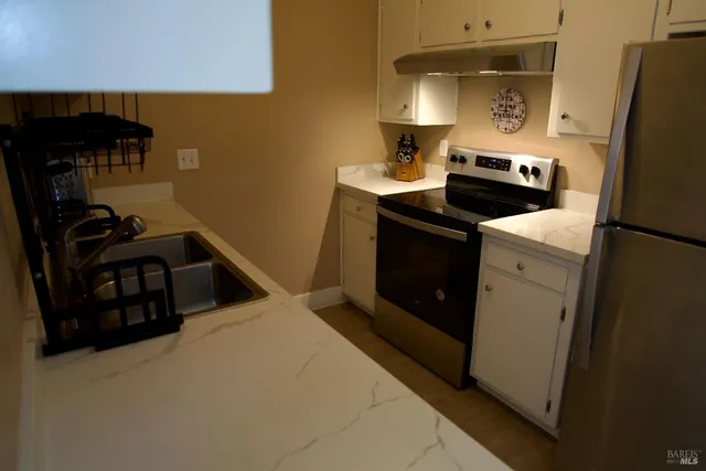 a kitchen with a sink appliances and cabinets