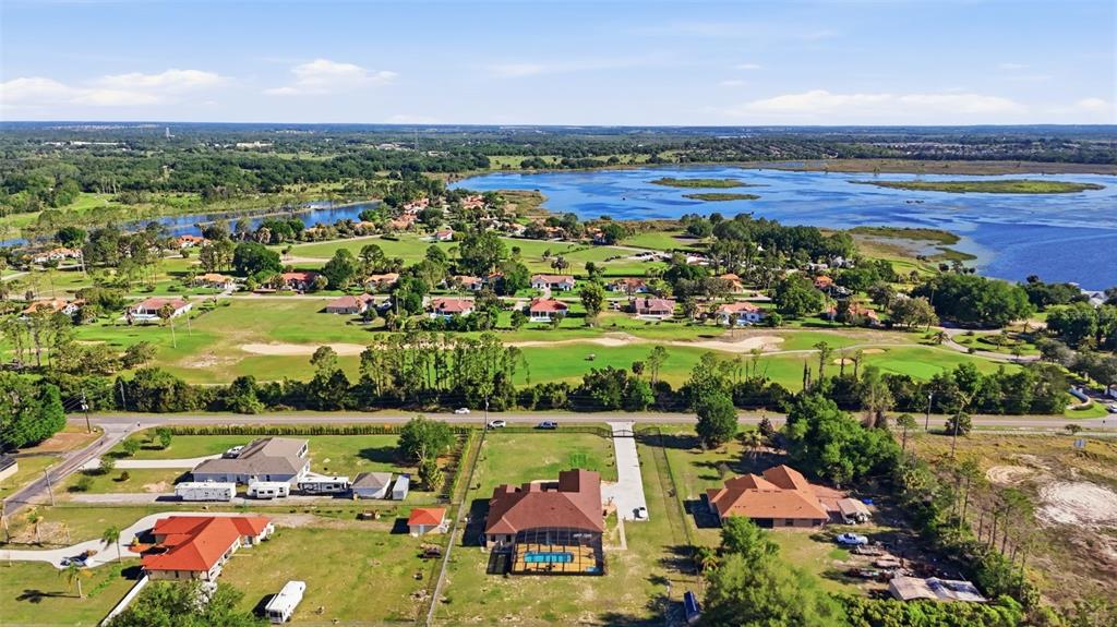 13429 Montevista Road Clermont, FL 34711 - Photo 3 of 89 an aerial view of lake and residential houses with outdoor space