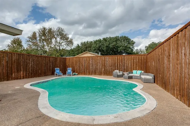 a view of a backyard with swimming pool