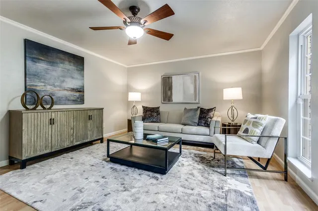 a living room with furniture a chandelier and a flat screen tv