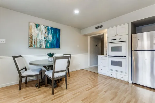a view of a dining room with furniture wooden floor and kitchen