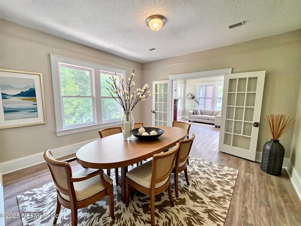 a view of a dining room with furniture window and wooden floor