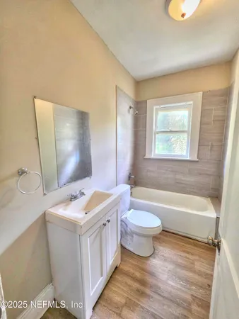 a bathroom with a sink a toilet and bathtub