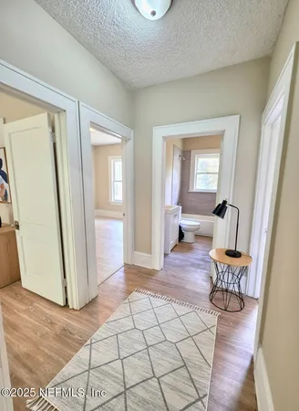 a view of a livingroom with wooden floor and furniture