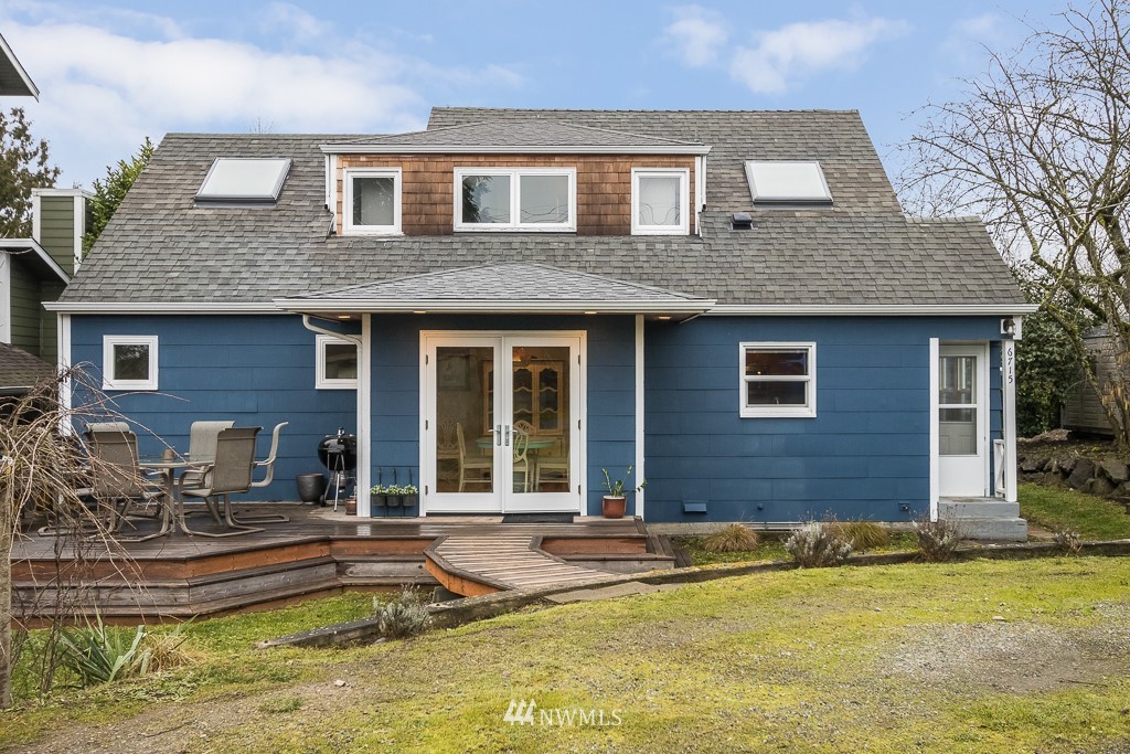 6715 35th Avenue Southwest Seattle, WA 98126 - Photo 1 of 31 a front view of a house with swimming pool
