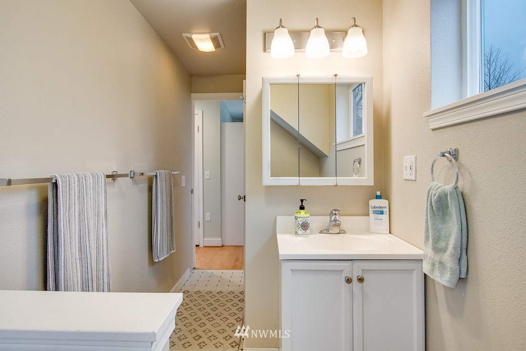 6715 35th Avenue Southwest Seattle, WA 98126 - Photo 18 of 31 a bathroom with a sink a toilet and shower