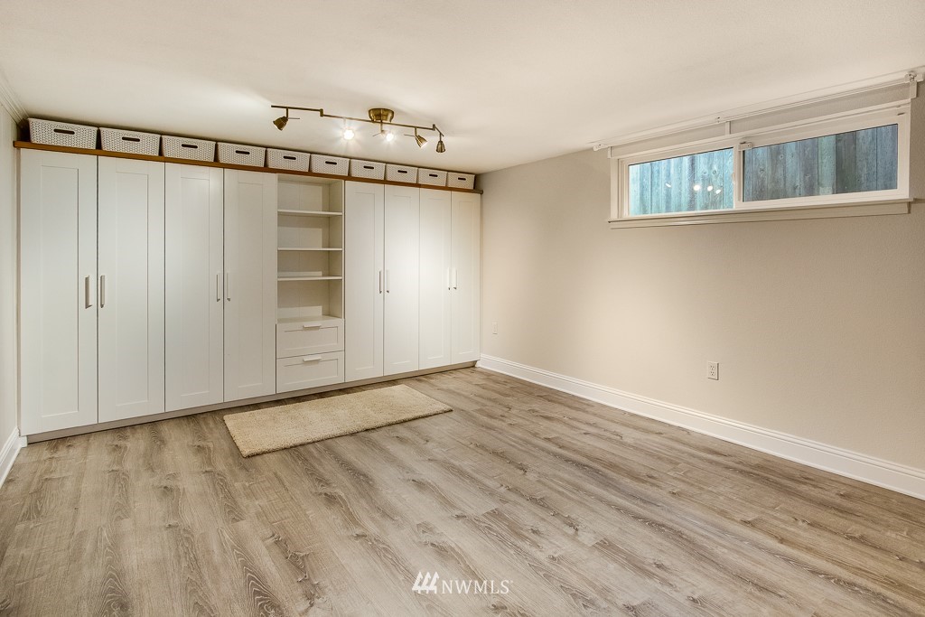 6715 35th Avenue Southwest Seattle, WA 98126 - Photo 22 of 31 a view of an empty room with wooden floor and a window