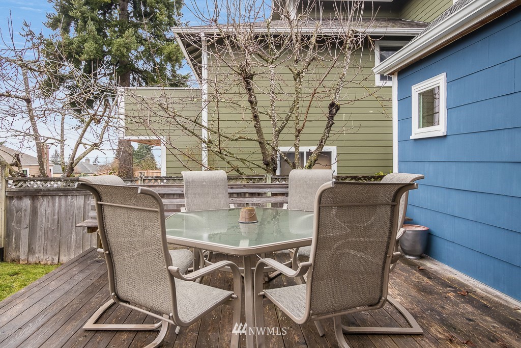 6715 35th Avenue Southwest Seattle, WA 98126 - Photo 27 of 31 a view of a patio with table and chairs with wooden floor and fence