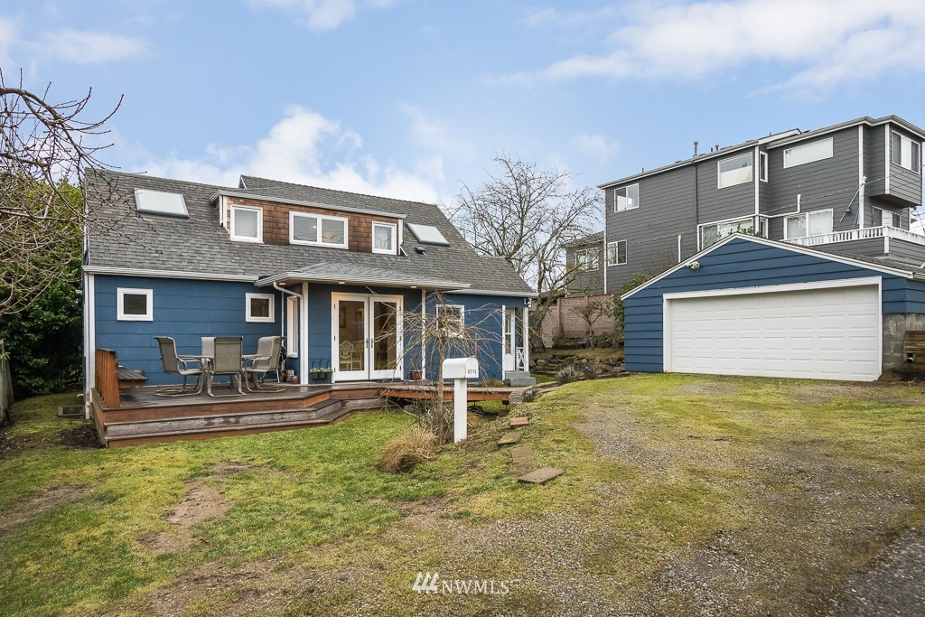 6715 35th Avenue Southwest Seattle, WA 98126 - Photo 28 of 31 a front view of a house with a yard table and chairs