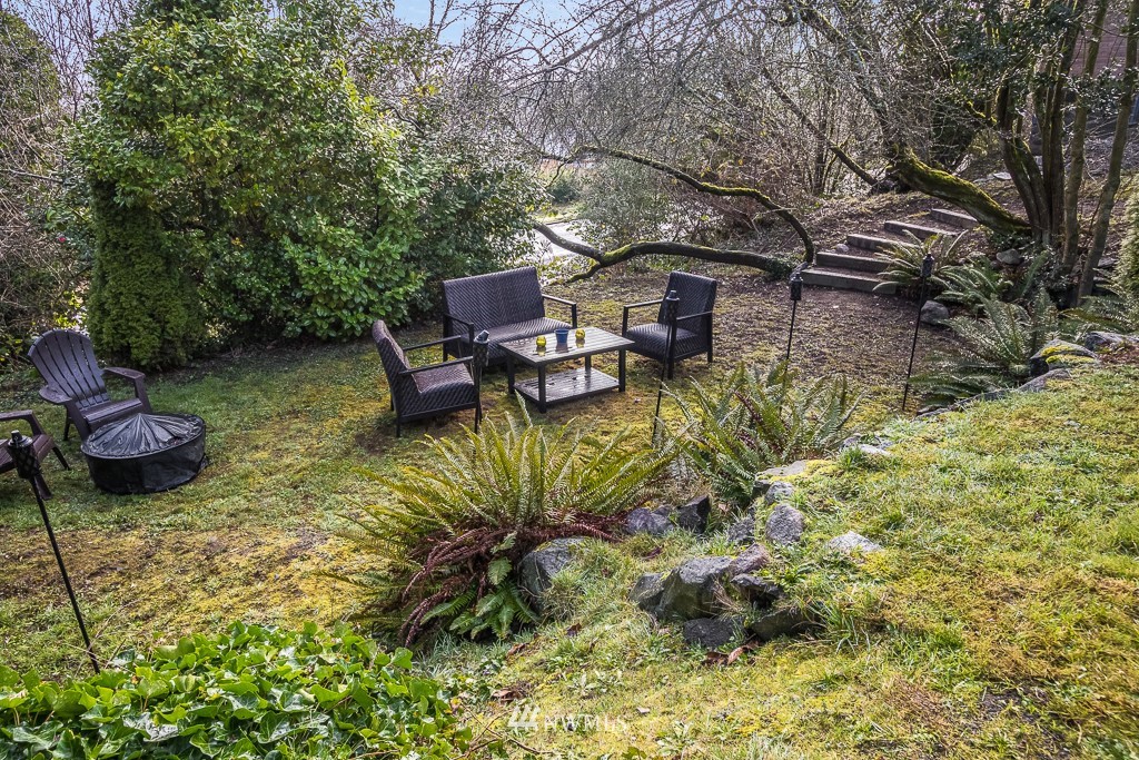 6715 35th Avenue Southwest Seattle, WA 98126 - Photo 30 of 31 a backyard of a house with table and chairs