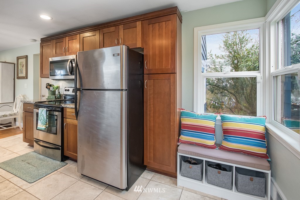 6715 35th Avenue Southwest Seattle, WA 98126 - Photo 10 of 31 a kitchen with stainless steel appliances a refrigerator and cabinets