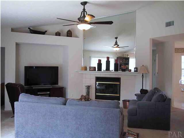 6973 Raburn Road Pensacola, FL 32526 - Photo 3 of 14 Large and open living area with wood-burning fireplace