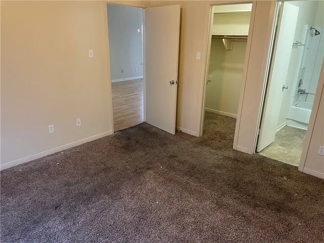 a white toilet sitting next to a bath tub