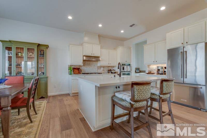 2537 Titanium Crest Drive Reno, NV 89521 - Photo 8 of 26 a kitchen with a sink a microwave a refrigerator and wooden floor