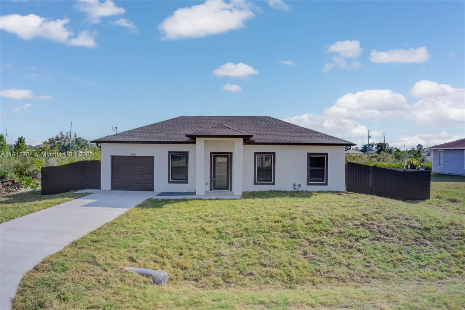 749 Roma Avenue South Lehigh Acres, FL 33974 - Photo 1 of 16 a house view with a garden space