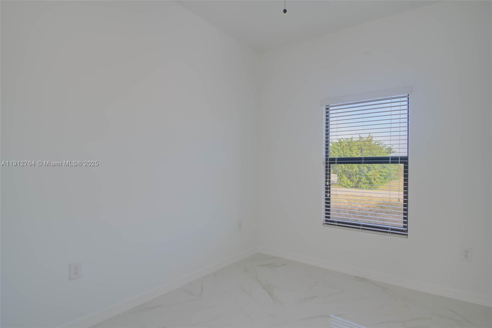 749 Roma Avenue South Lehigh Acres, FL 33974 - Photo 11 of 16 a view of an empty room with a window
