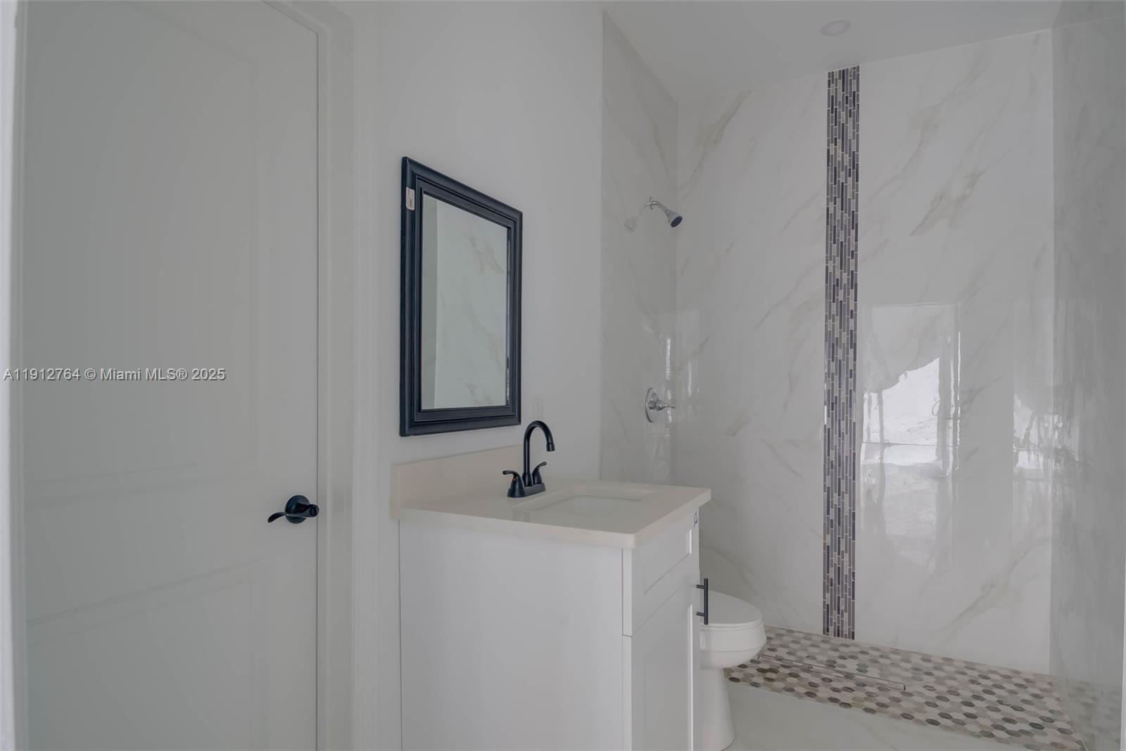 749 Roma Avenue South Lehigh Acres, FL 33974 - Photo 15 of 16 a bathroom with a sink and a mirror