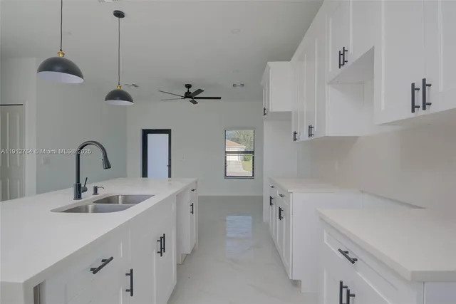 a kitchen with a sink appliances and cabinets