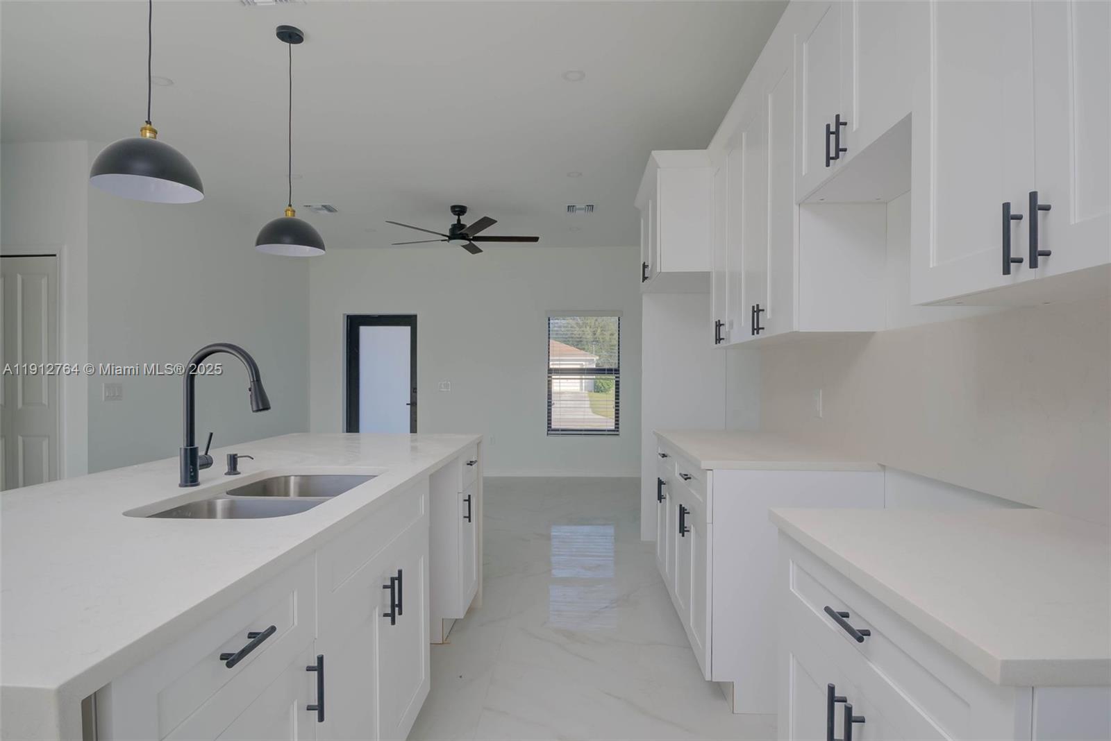 749 Roma Avenue South Lehigh Acres, FL 33974 - Photo 6 of 16 a kitchen with a sink appliances and cabinets