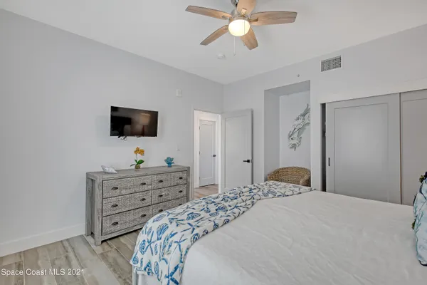a bathroom with a granite countertop sink a toilet a mirror and shower