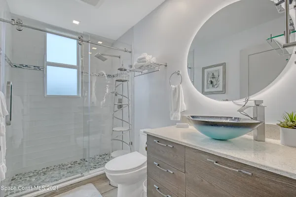 a living room with a bed and a flat screen tv