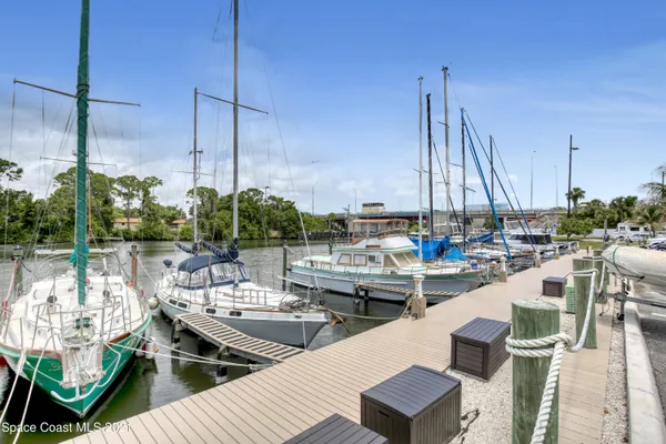 a front view of a house with a yard and potted plants