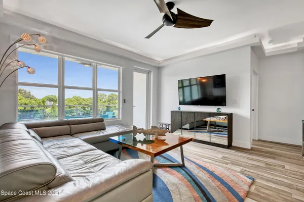 a view of a kitchen with a sink and wooden floor