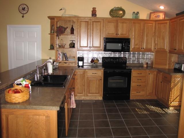 1207 Rabbit Run Road Goodview, VA 24095 - Photo 7 of 36 a kitchen with a sink a stove and cabinets