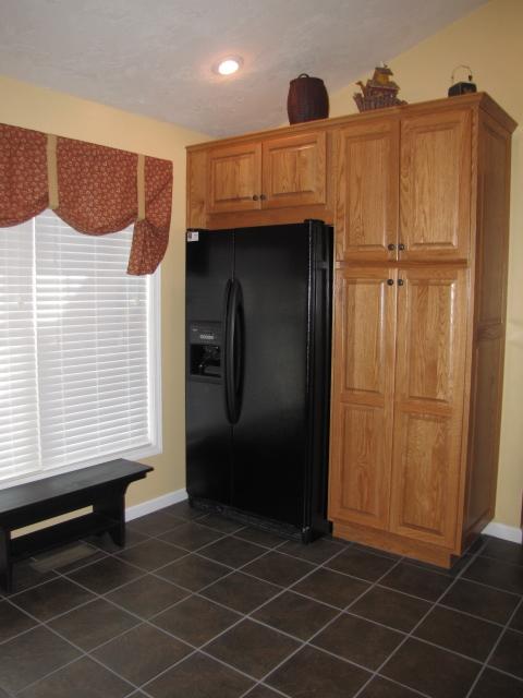 1207 Rabbit Run Road Goodview, VA 24095 - Photo 9 of 36 a kitchen with a sink a refrigerator and cabinets