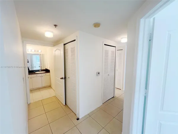 a view of a storage and utility room with a sink
