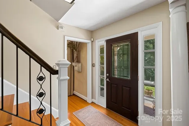 a view of an entryway with wooden floor and door