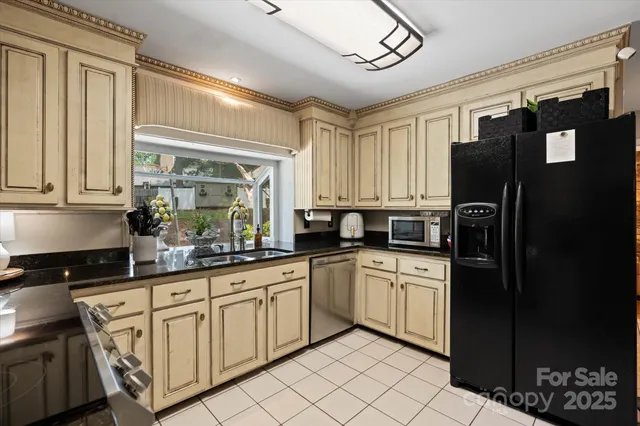 a kitchen with stainless steel appliances granite countertop a refrigerator and a sink