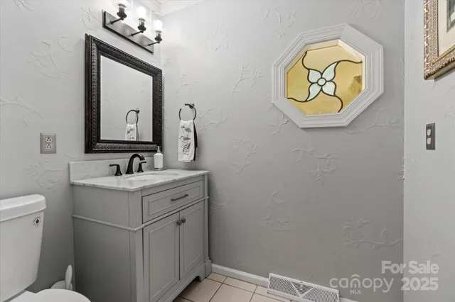 a bathroom with a sink mirror and vanity