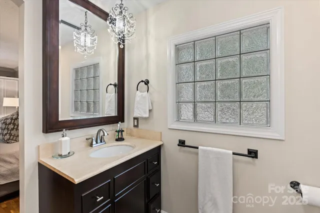 a bathroom with a sink vanity and a mirror
